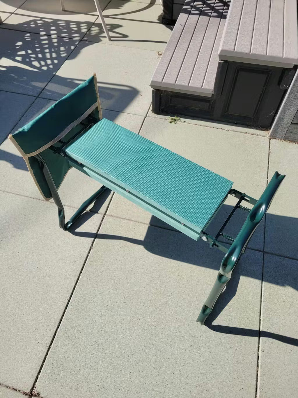 Teal lounge chair on a concrete patio