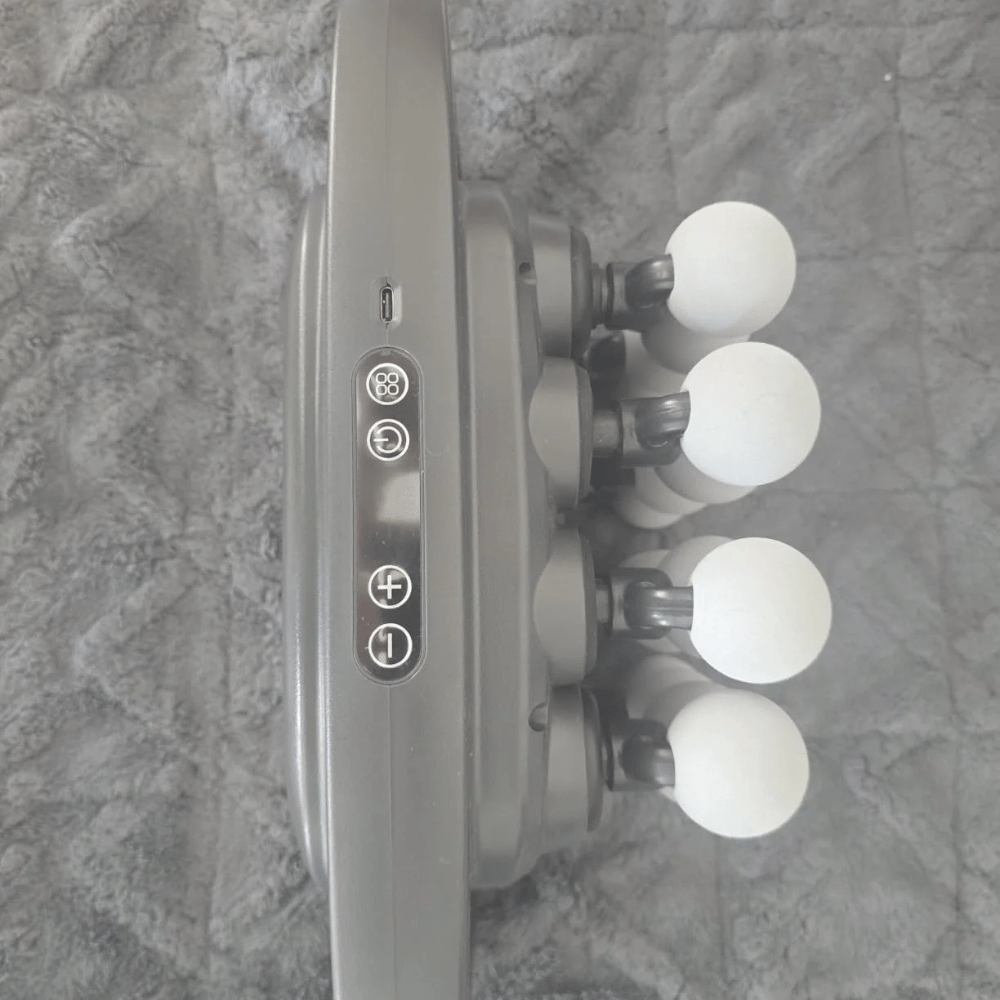 Close-up of a shower head with four nozzles on a textured gray background