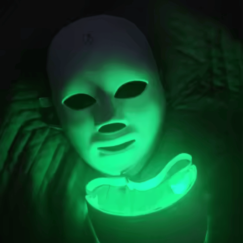 Person wearing a glowing green mask in a dark setting