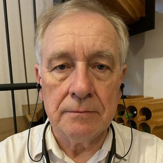 Man wearing a white shirt with a blurred background